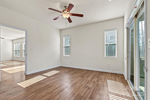 unfurnished room with hardwood / wood-style flooring and ceiling fan