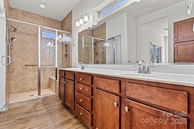 bathroom with vanity, an enclosed shower, and hardwood / wood-style flooring