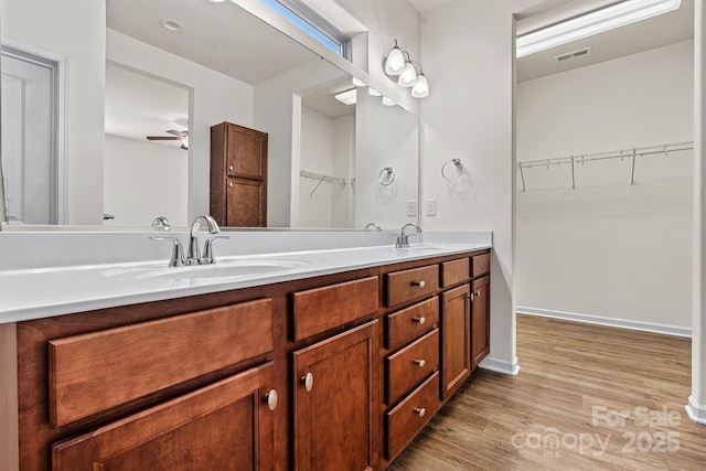 bathroom with vanity, wood-type flooring, and ceiling fan