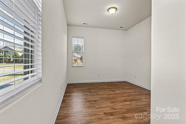 unfurnished room with dark hardwood / wood-style floors