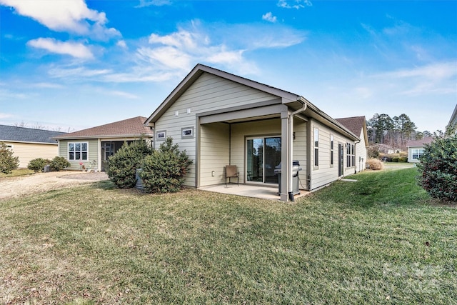 back of property featuring a patio and a lawn