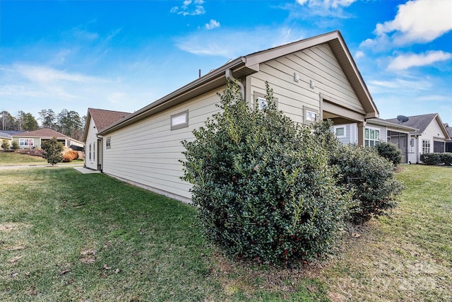 view of side of home featuring a yard