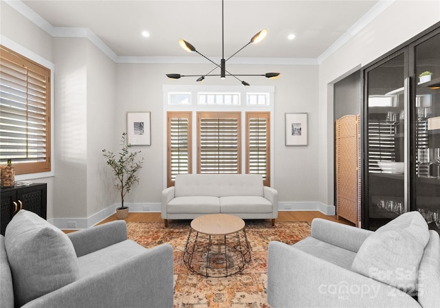 living area featuring a wealth of natural light, wood finished floors, and ornamental molding