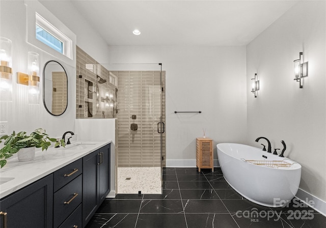 bathroom with a soaking tub, baseboards, a stall shower, and a sink