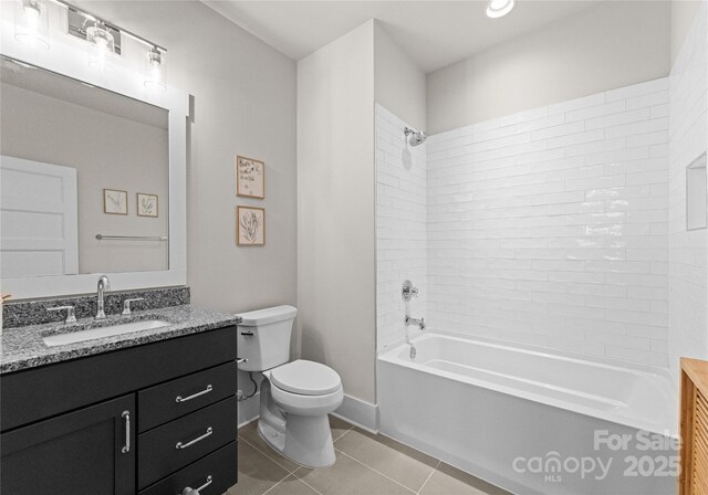 full bath featuring tile patterned flooring, toilet, vanity, and tub / shower combination