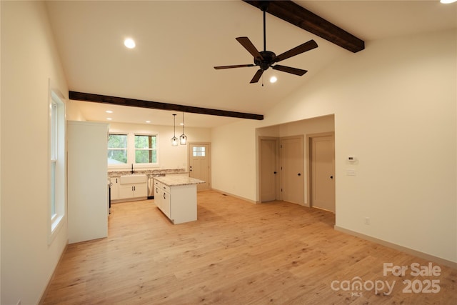 unfurnished living room featuring ceiling fan, beamed ceiling, recessed lighting, and light wood-style flooring