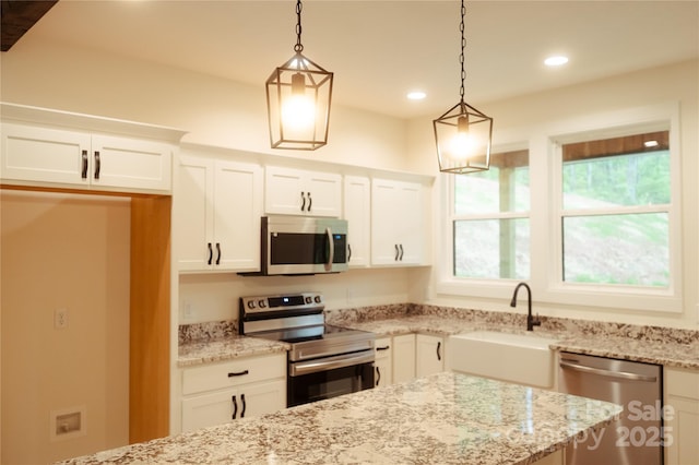 kitchen featuring white cabinets, recessed lighting, appliances with stainless steel finishes, and a sink