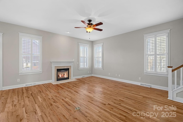 unfurnished living room featuring ceiling fan and light wood-type flooring