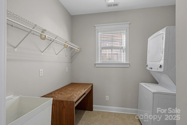 clothes washing area with stacked washer and dryer and sink