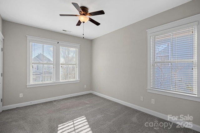 carpeted spare room with ceiling fan