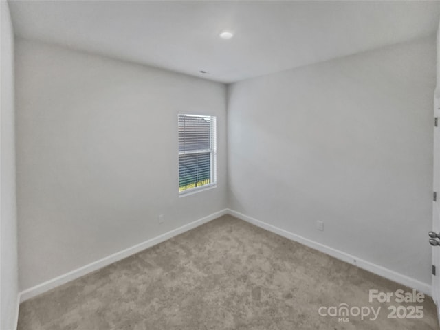 spare room with light carpet