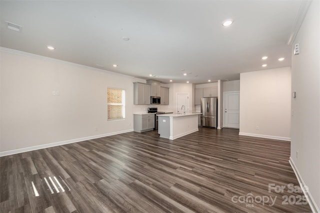 unfurnished living room with sink, dark wood-type flooring, and ornamental molding