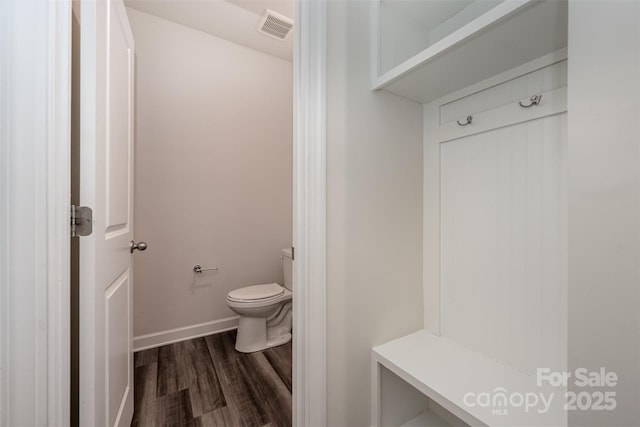 bathroom featuring hardwood / wood-style floors and toilet