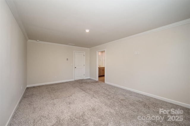 carpeted spare room with crown molding