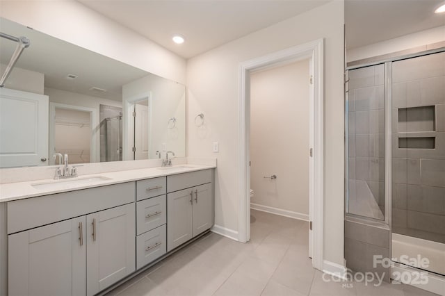 bathroom featuring tile patterned floors, vanity, toilet, and a shower with door