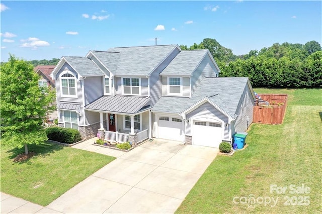 view of front of property with a garage, covered porch, and a front lawn