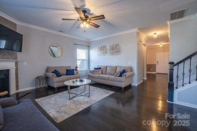 living room with ceiling fan, ornamental molding, and dark hardwood / wood-style floors