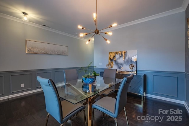 dining room featuring a notable chandelier, ornamental molding, and dark hardwood / wood-style floors