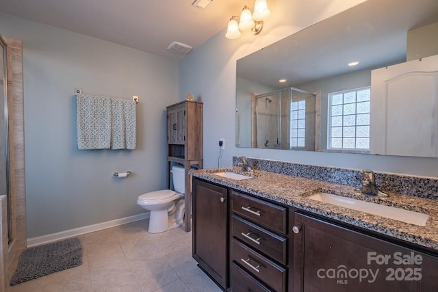 bathroom featuring vanity, tile patterned flooring, a shower with shower door, and toilet