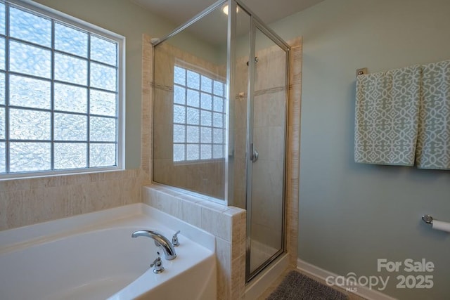 bathroom with plus walk in shower and a wealth of natural light