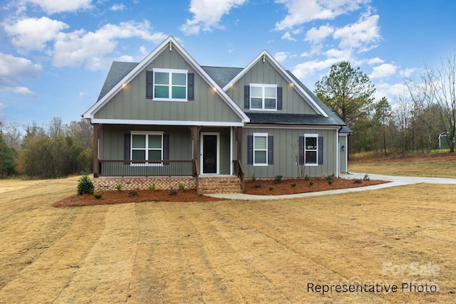 craftsman-style home with a porch and a front yard