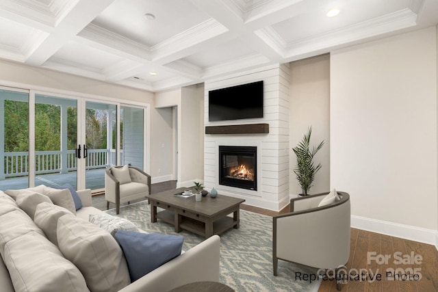 living room featuring beamed ceiling, coffered ceiling, dark wood-type flooring, and a large fireplace