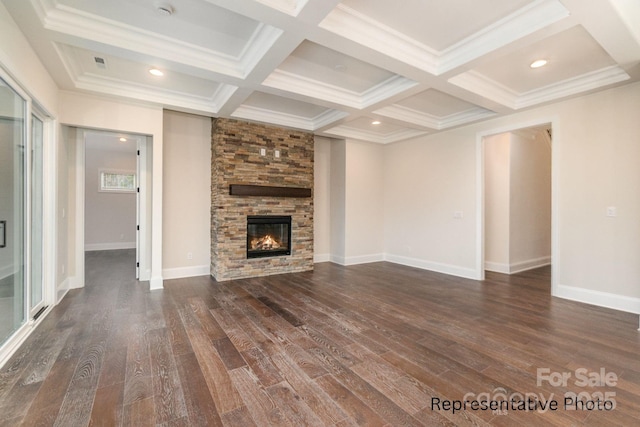 unfurnished living room featuring coffered ceiling, a stone fireplace, dark hardwood / wood-style floors, and beam ceiling