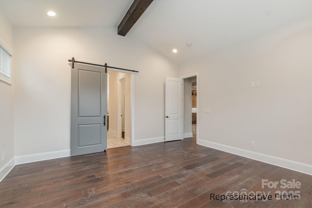 unfurnished bedroom with dark hardwood / wood-style flooring, vaulted ceiling with beams, and a barn door