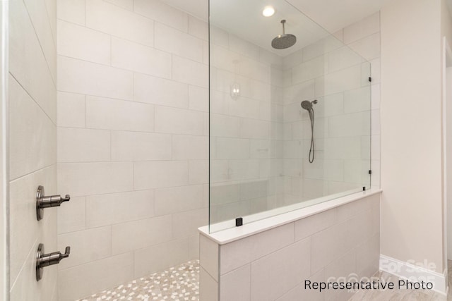 bathroom with tiled shower