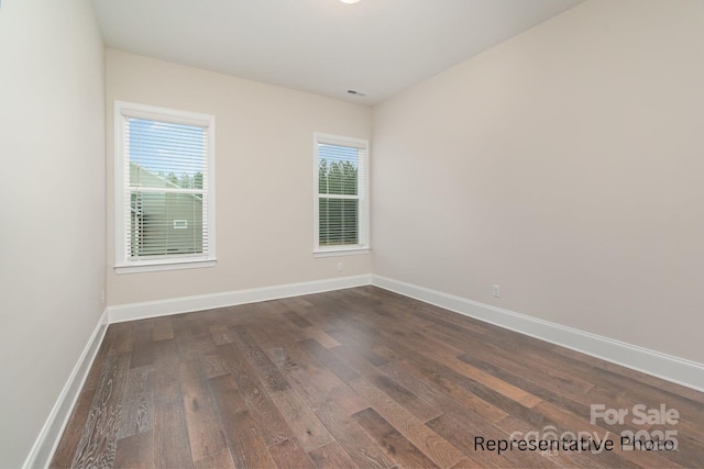 empty room featuring dark hardwood / wood-style flooring