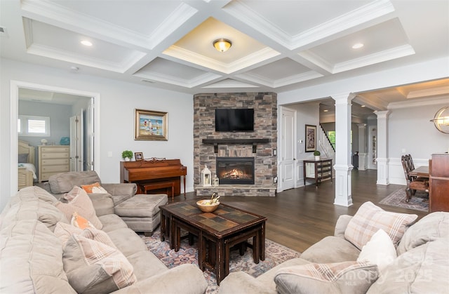 living room featuring decorative columns, hardwood / wood-style flooring, coffered ceiling, and a fireplace