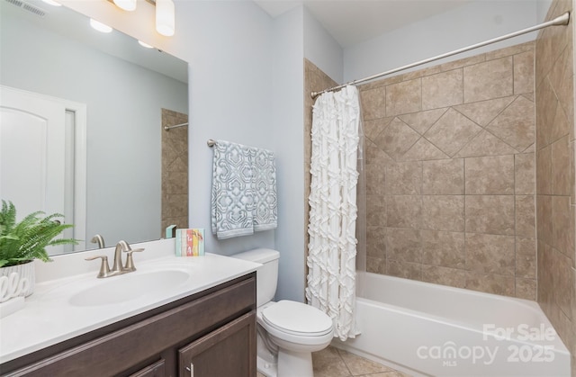 full bathroom featuring shower / tub combo, vanity, tile patterned floors, and toilet