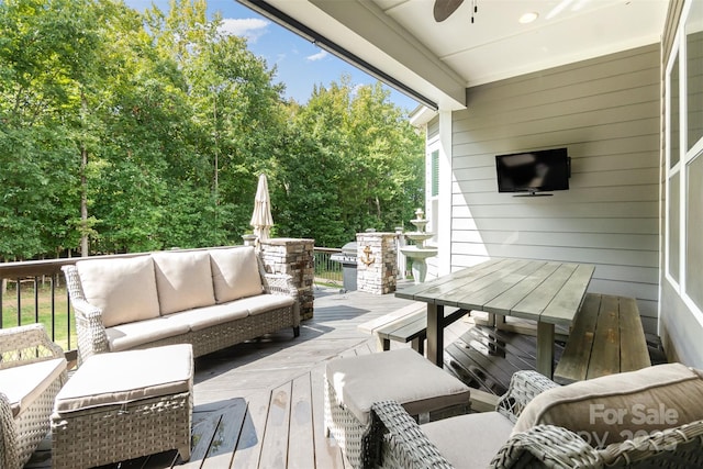 wooden terrace with outdoor lounge area and ceiling fan