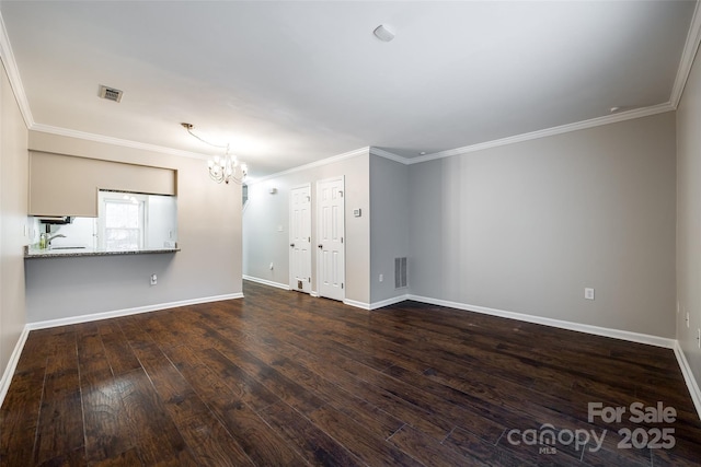 unfurnished living room with dark hardwood / wood-style flooring, a notable chandelier, crown molding, and sink