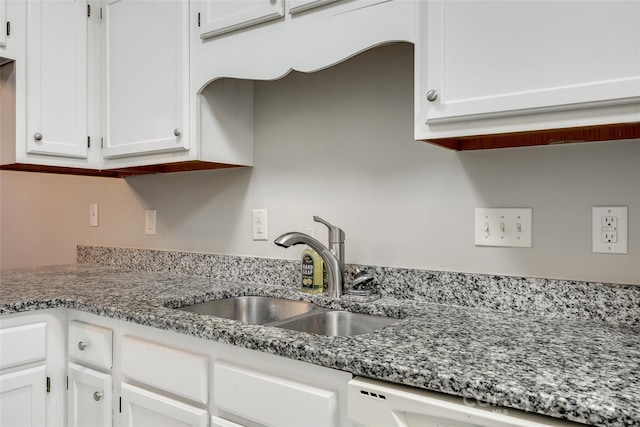 kitchen with white cabinetry, sink, and dishwasher