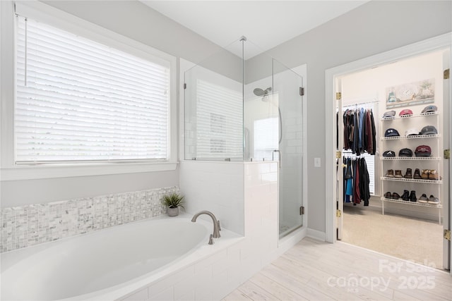 bathroom featuring separate shower and tub