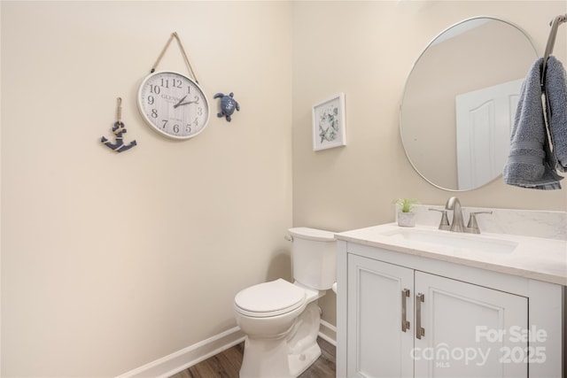 bathroom featuring vanity, hardwood / wood-style floors, and toilet