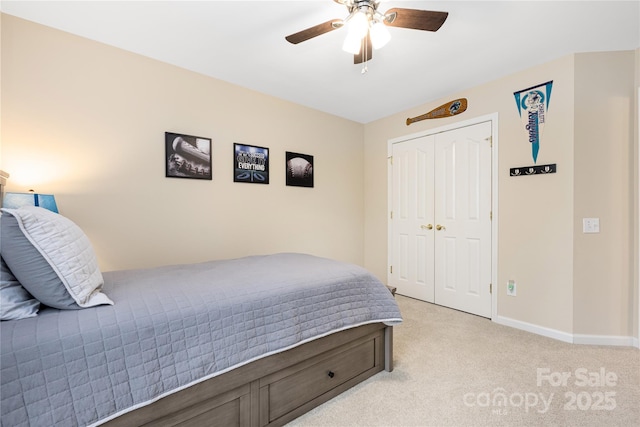 carpeted bedroom with a closet and ceiling fan