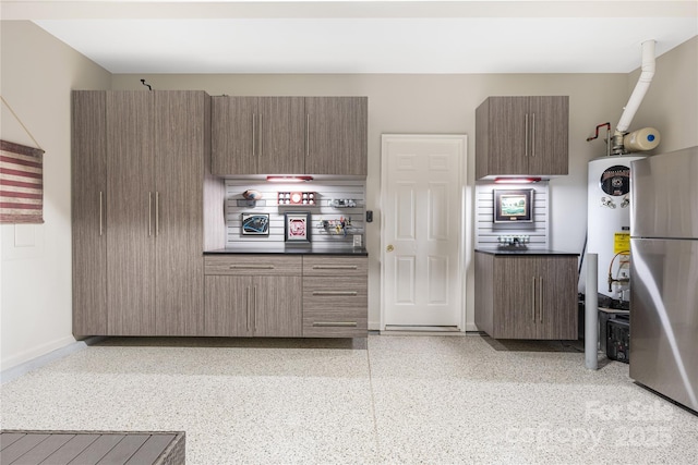 kitchen featuring water heater and stainless steel refrigerator