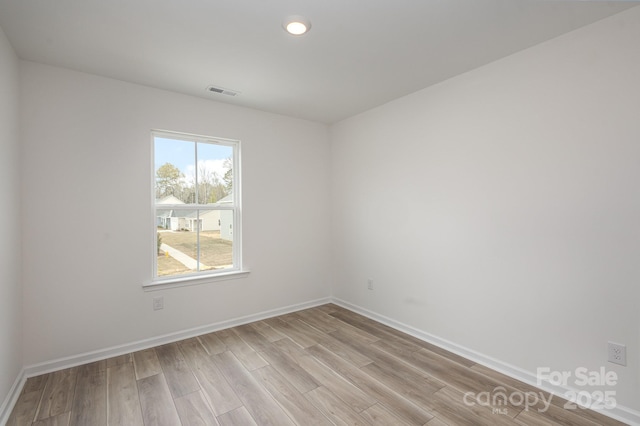 spare room featuring light wood-type flooring