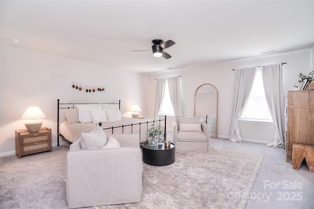 bedroom featuring multiple windows, carpet flooring, visible vents, and baseboards