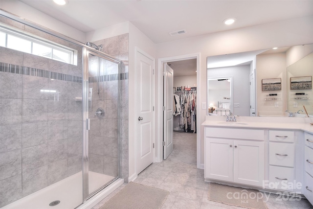 bathroom featuring a stall shower, visible vents, and vanity