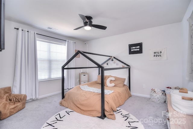 carpeted bedroom featuring a ceiling fan, visible vents, and baseboards