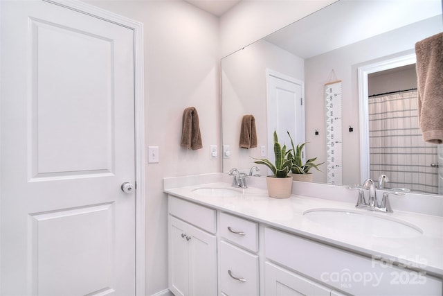 bathroom featuring double vanity and a sink