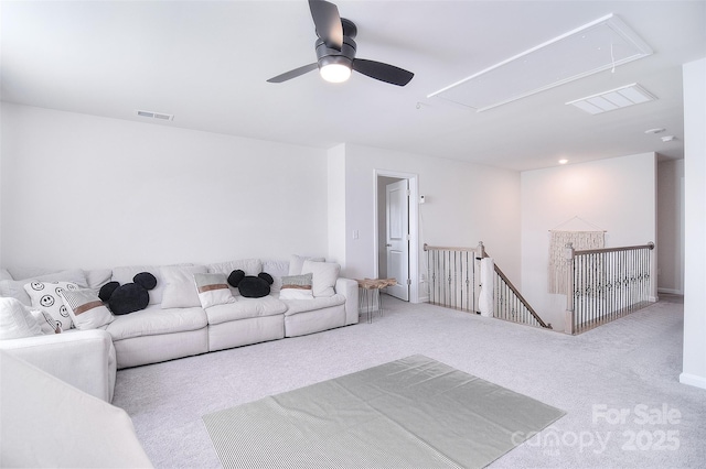 living room featuring carpet floors, attic access, and visible vents