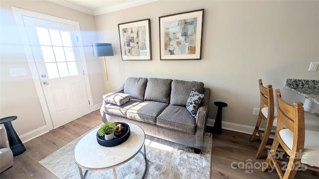 living room with dark hardwood / wood-style flooring and ornamental molding