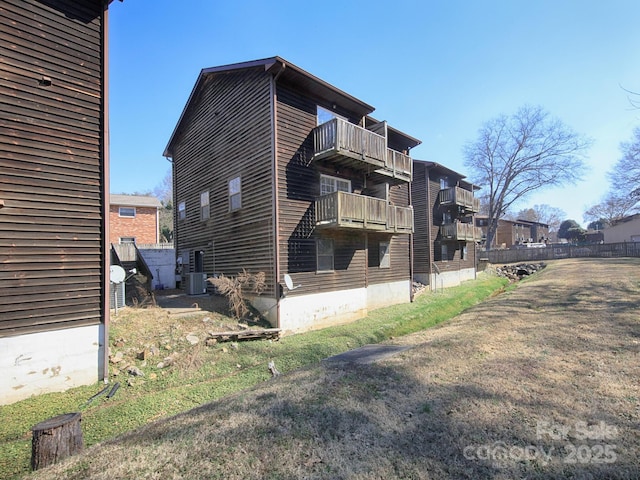 view of property exterior featuring cooling unit and a balcony