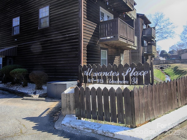 view of home's exterior featuring a fenced front yard and a balcony