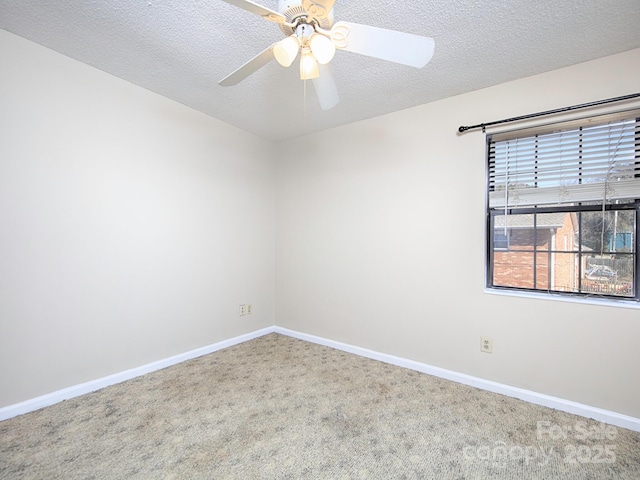 unfurnished room featuring carpet floors, ceiling fan, a textured ceiling, and baseboards