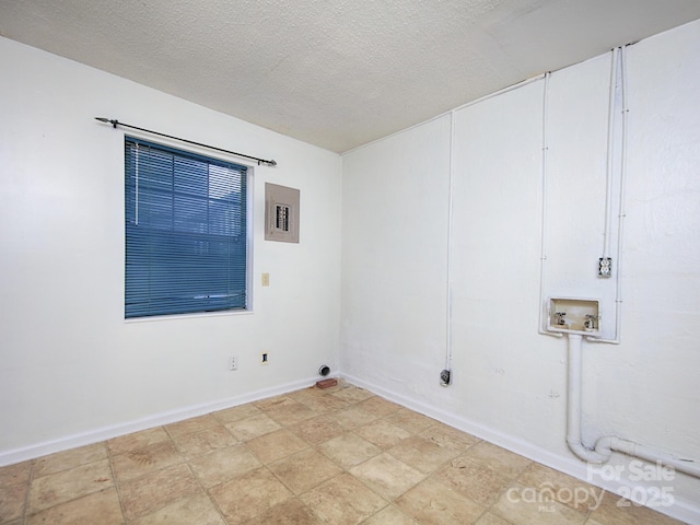 laundry room featuring laundry area, hookup for a washing machine, baseboards, and a textured ceiling